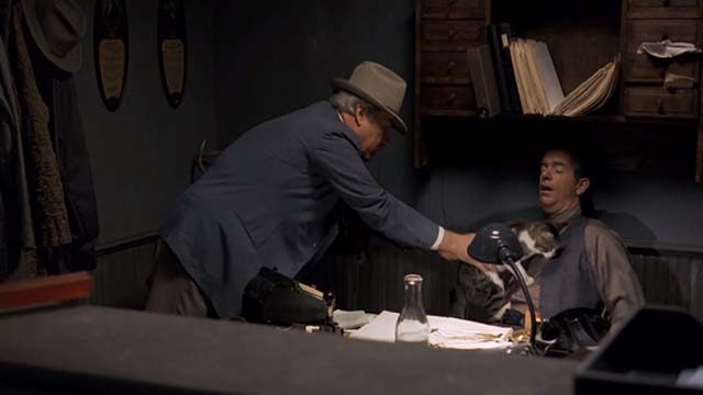 The Trip to Bountiful - Sheriff Richard Bradford placing tabby and white cat on sleeping Roy Kevin Cooney