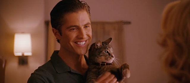 The Ugly Truth - Colin Eric Winter holding brown tabby cat D'Artagnan