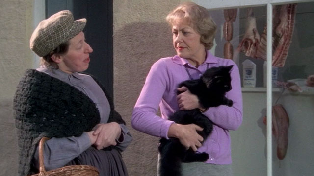 Under Milk Wood - Mrs.  Beynon holding longhair black cat with Mrs. Dai Bread One Dorothea Phillips