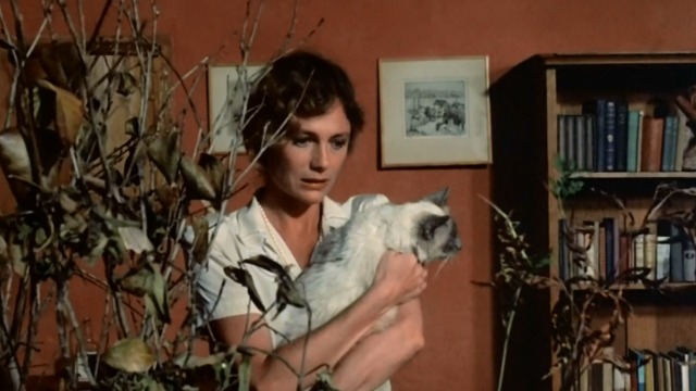 Under the Volcano - Yvonne Jacqueline Bisset holding Burmese cat Oedipus while looking at dead plants
