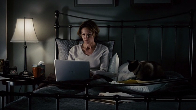 Untraceable - Siamese cat sitting on pillow with Jennifer Marsh Diane Lane on bed
