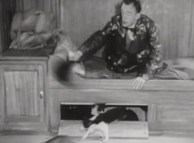 Utopia - Stan Laurel on bunk shooing at cats in compartment