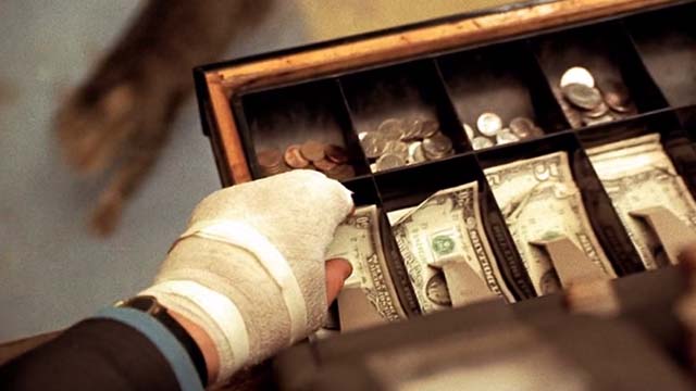 U Turn - tabby cat Chester below cash register drawer