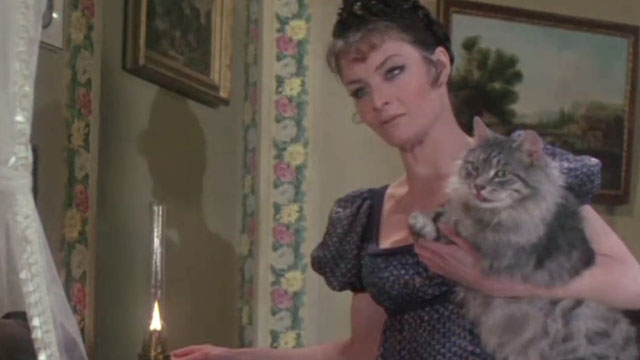 The Vampire Lovers - longhair grey tabby cat Gustav blepping while held by Mme. Perrodot Kate O’Mara