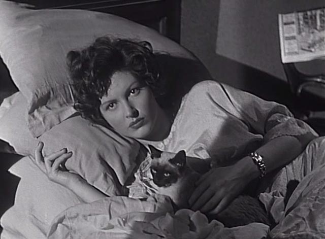 Variety Lights - Liliana Carla Del Poggio lying on bed with Siamese cat
