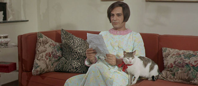 Vedo nudo - I See Naked - Ornella Nino Manfredi sitting on couch with tabby and white cat Fabiola wearing red ribbon