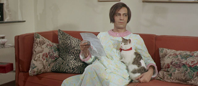 Vedo nudo - I See Naked - Ornella Nino Manfredi sitting on couch with tabby and white cat Fabiola wearing red ribbon