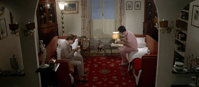 Vedo nudo - I See Naked - Ornella Nino Manfredi sitting on sofa bed across from Carlos with tabby and white cat Fabiola between them