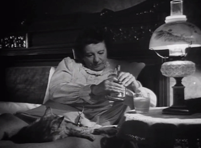 The Verdict - large long-haired tabby cat on bed with Mrs. Benson Rosalind Ivan as she pours liquor into milk