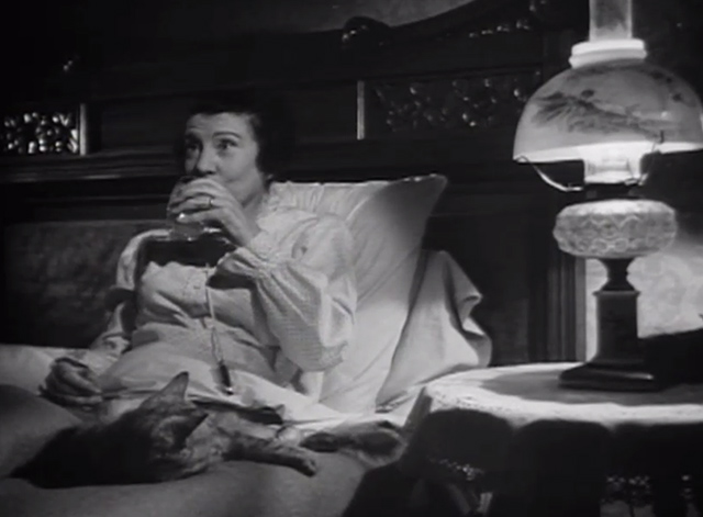 The Verdict - large long-haired tabby cat on bed with Mrs. Benson Rosalind Ivan as she drinks spiked milk