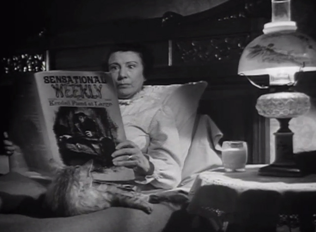 The Verdict - large long-haired tabby cat on bed with Mrs. Benson Rosalind Ivan as she reads sensational magazine about murders