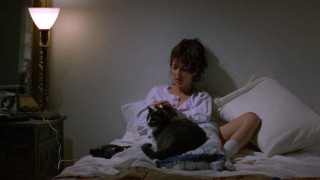Walking and Talking - Amelia Catherine Keener in bed with gray and white cat Big Jeans