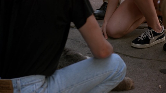 Walking and Talking - body of gray and white cat Big Jeans lying on sidewalk