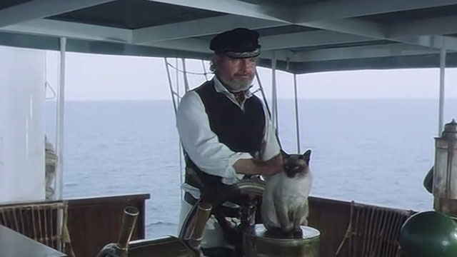 Warlords of Atlantis - Captain Daniels Shane Rimmer petting Siamese cat on boat