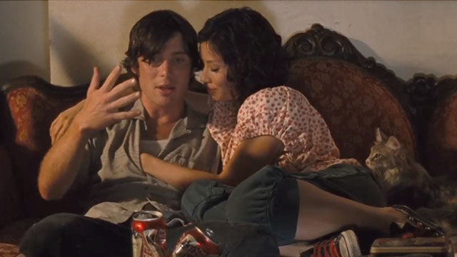 Watching the Detectives - Neil Cillian Murphy and Violet Lucy Liu sitting on couch with longhair pastel calico cat