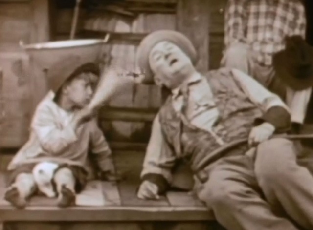 Way Down East - white kitten sitting between boy's legs as he fans Constable