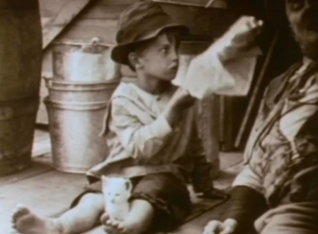 Way Down East - white kitten sitting between fanning boy's legs