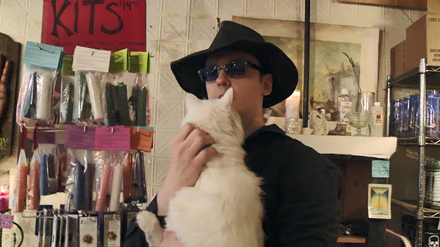 West of Memphis - Damien Echols holding long-haired white cat in New York shop