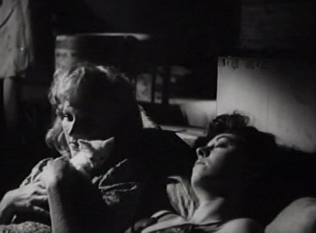 Without Pity - Angela holding white kitten in bed with Marcella