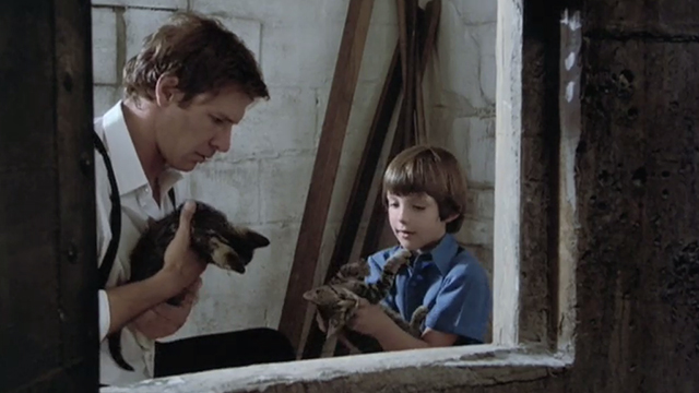 Witness - Samual Lukas Haas holding tabby kitten upside down with John Book Harrison Ford also holding kitten outside grain silo