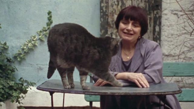 The World of Jacques Demy - Agnès Varda with gray tabby cat Zgougou on table