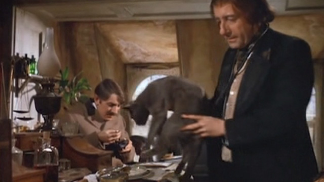 The Wrong Box - Dr. Pratt Peter Sellers lifts gray cat Basil from chair