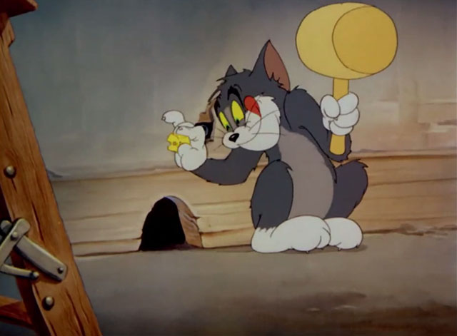 The Yankee Doodle Mouse - Tom cartoon cat sitting outside mouse hole with cheese and mallet