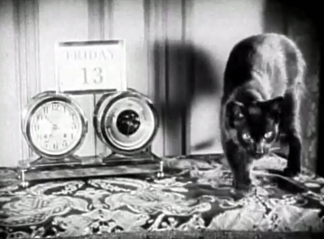 You'd Be Surprised - black cat Felix next to clock barometer and calendar with date Friday the 13th