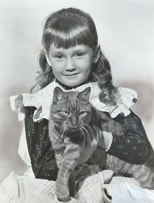 Behind the Scenes of Thomasina - publicity photo of Karen Dotrice as Mary MacDhui holding marmalade tabby cat Thomasina