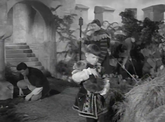 The Adventures of Robin Hood - The Final Tax - Simon Barry Fennell carrying large longhair tabby cat Peterkin into courtyard