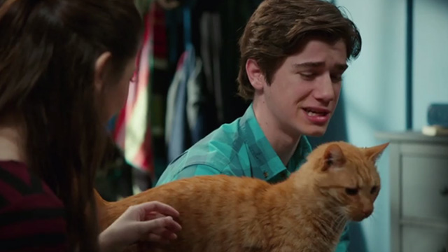 American Housewife - Grandma's Way - ginger tabby cat Mittens on bed between Oliver Daniel DiMaggio and Gina Nikki Hahn