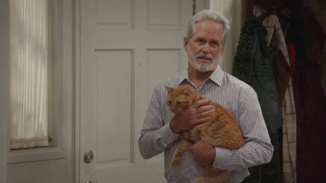 American Housewife - Grandma's Way - Dan Gregory Harrison walking to door with ginger tabby cat Mittens
