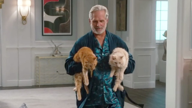 American Housewife - Highs and Lows - Dan Gregory Harrison carrying ginger tabby cat Mittens and long haired cream cat