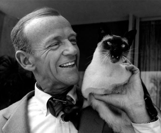 Fred Astaire with his pet Siamese cat Carlyle