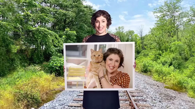 Call Me Kat - Plus One - Kat Mayim Bialik holding photo of herself with ginger tabby cat