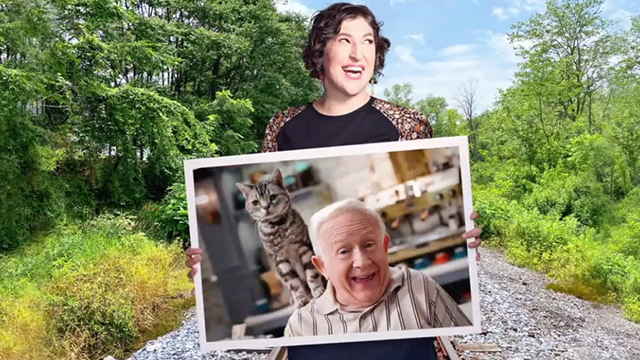 Call Me Kat - Plus One - Kat Mayim Bialik holding photo of Phil Leslie Jordan with silver tabby cat