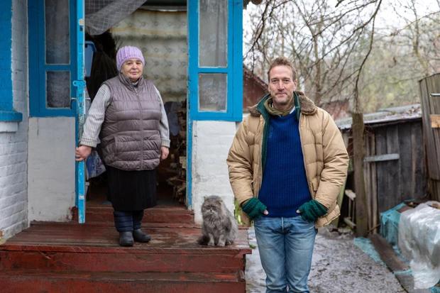 Chernobyl - longhair gray cat sitting on porch with Valetina and Ben Fogle