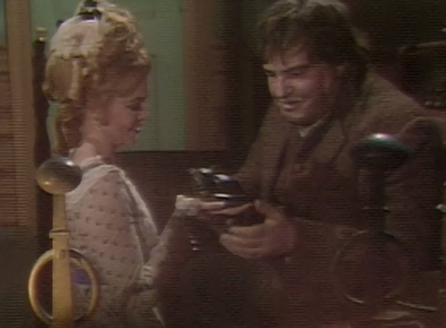 Dark Shadows - Angelique Lara Parker holding out a sculpture of cat to Ben Thayer David