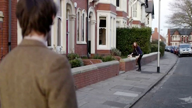 Doctor Who - The Lodger - Matt Smith on street looking at Amy Karen Gillan stops to pet longhair seal point cat on wall