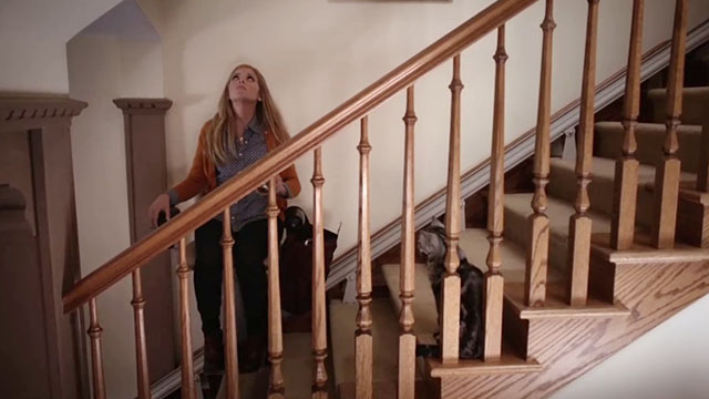 Don't Trust the B---- in Apartment 23 - It's a Miracle - June Dreama Walker riding stairlift chair up stairs with tabby cat Freckles watching
