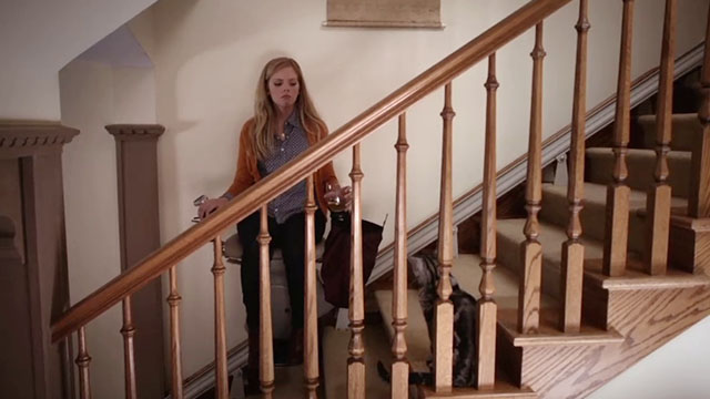 Don't Trust the B---- in Apartment 23 - It's a Miracle - June Dreama Walker riding stairlift chair up stairs with tabby cat Freckles watching