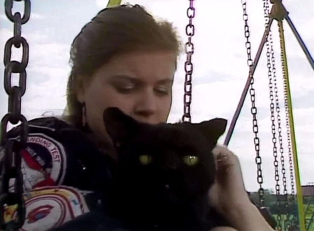 Doctor Who - Survival - Ace Sophie Aldred holding black cat Kitling on swing