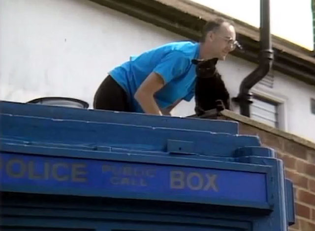 Doctor Who - Survival - crew member on top of TARDIS with Sooty black animatronic cat