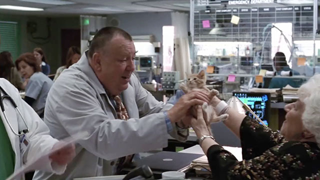 ER - Tandem Repeats - Roxanne Charlotte Rae handing ginger tabby kitten Purdy to Frank Troy Evans