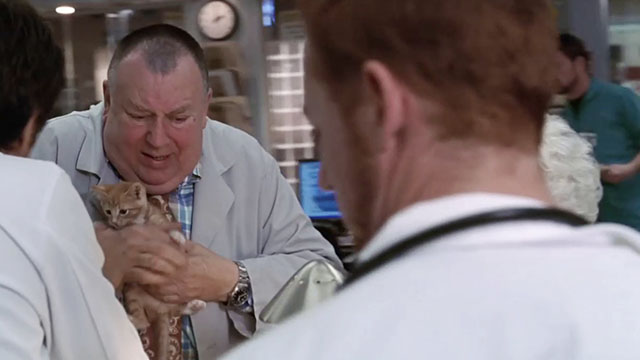 ER - Tandem Repeats - Frank Troy Evans holding ginger tabby kitten Purdy