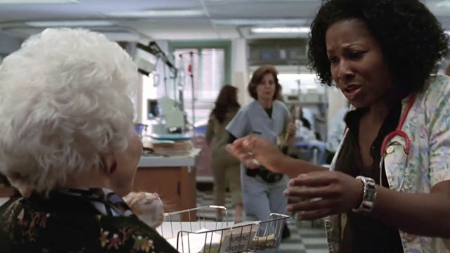 ER - Tandem Repeats - Dawn Angel Laketa Moore looking at ginger tabby kitten Purdy held by Roxanne Charlotte Rae