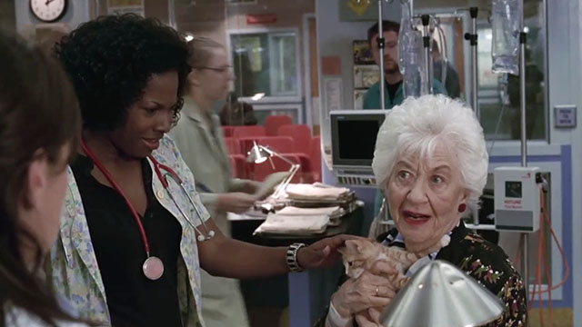 ER - Tandem Repeats - Dawn Angel Laketa Moore looking at ginger tabby kitten Purdy held by Roxanne Charlotte Rae