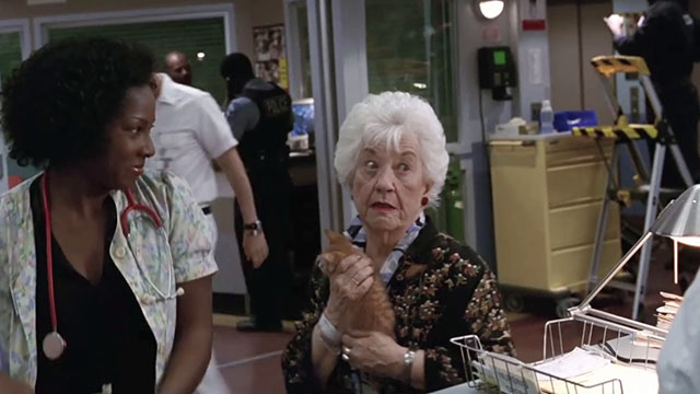 ER - Tandem Repeats - Dawn Angel Laketa Moore looking at ginger tabby kitten Purdy held by Roxanne Charlotte Rae