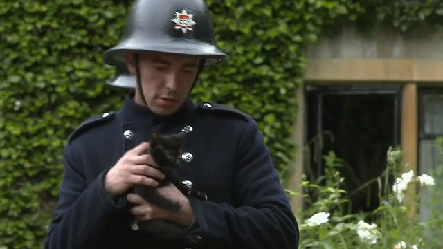 Father Brown - The Theatre of the Invisible - fireman carrying black kitten to safety