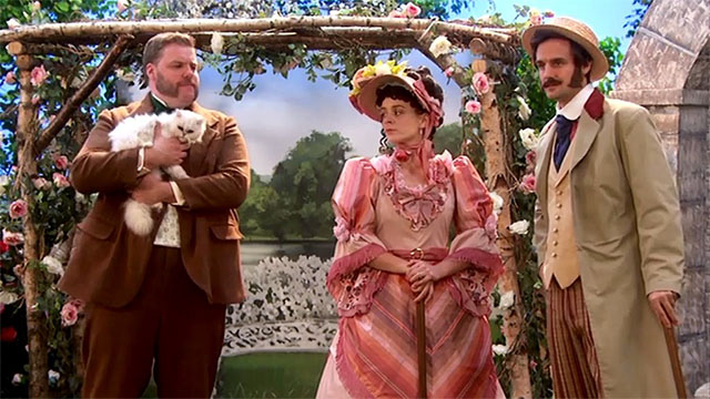 The Goes Wrong Show - Harper's Locket - Bernard Robert Henry Lewis holding white Persian cat on lawn with Celeste Sandra Charlie Russell and Edwin Chris Henry Shields